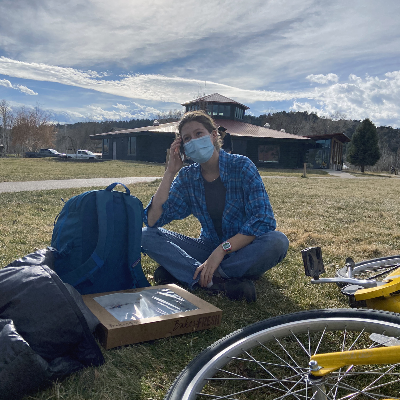 Student sitting in the quad calling their representatives