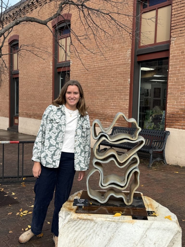 Sara Jensen '19 with one of her sculptures displayed in Carbondale